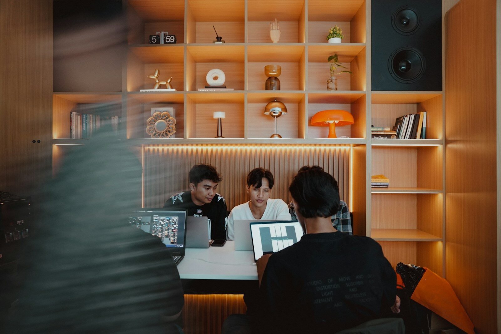 Three people working together on their computers.